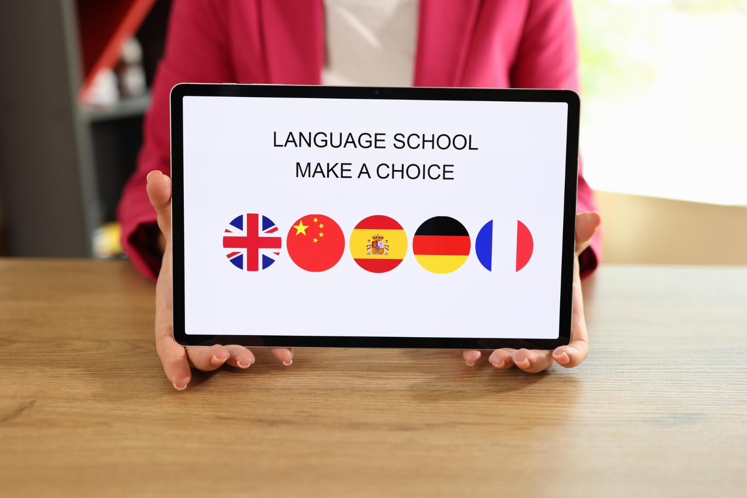 Woman-holds-tablet-with-text-language-school-and-offers-to-choose-foreign-language-to-study