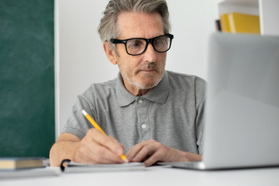 Senior-man-doing-online-classes-laptop