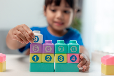 Little-child-girl-playing-colorful-blocks-2025-02-12-17-22-29-utc